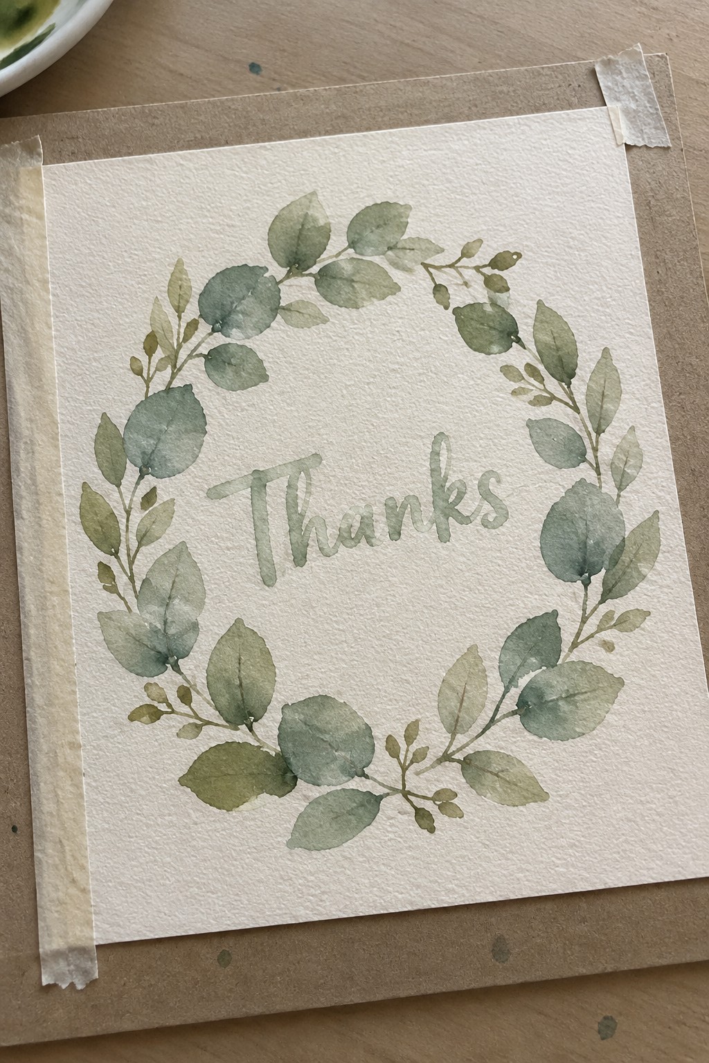 Watercolor green leaf wreath encircling