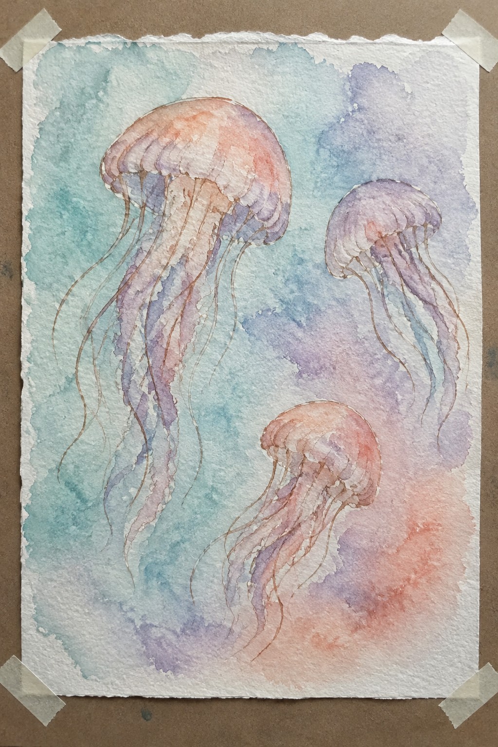 Three jellyfish with pink-orange bells and flowing tentacles in soft blue-purple watercolor.