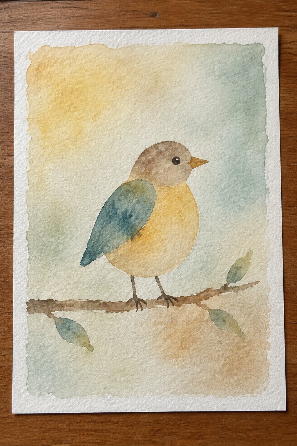 Watercolor painting of a yellow bird with blue wing perched on a leafy branch