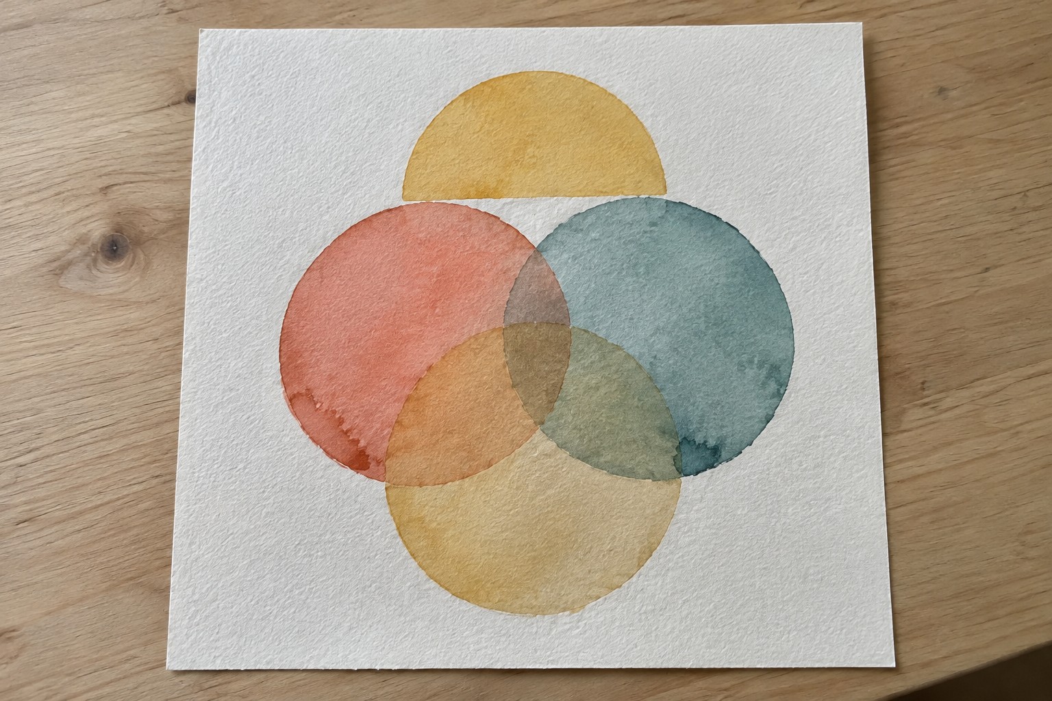 Abstract watercolor with overlapping coral, yellow, teal, and green circles on paper