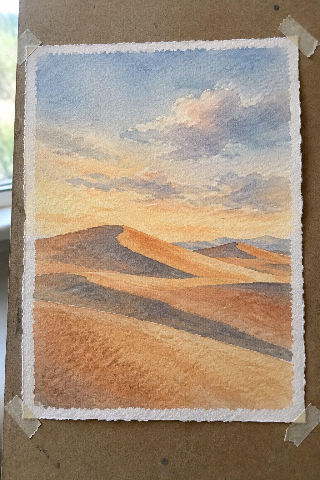 Watercolor painting of orange desert dunes under a vibrant sunset sky