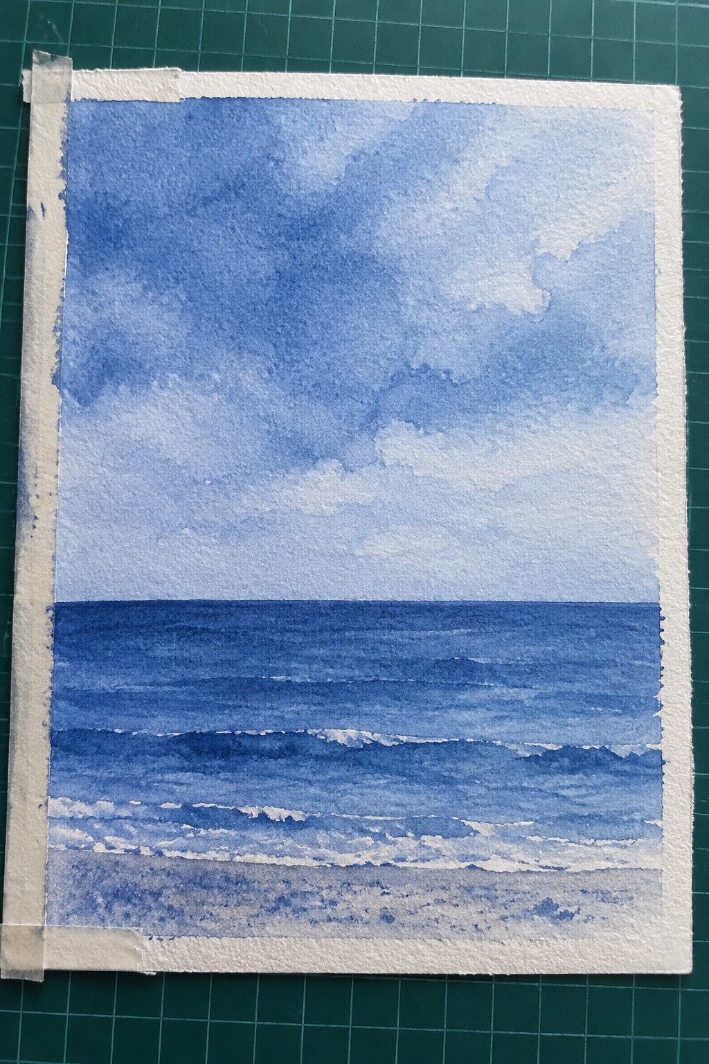 Blue watercolor seascape of ocean waves on sandy beach under cloudy sky
