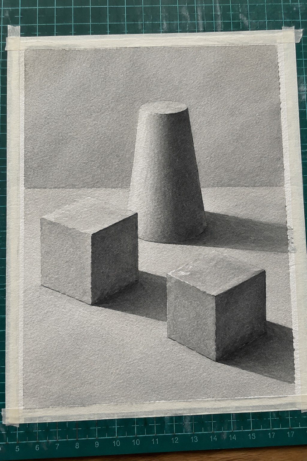 Graphite drawing of two cubes and a cone with shadows on green mat