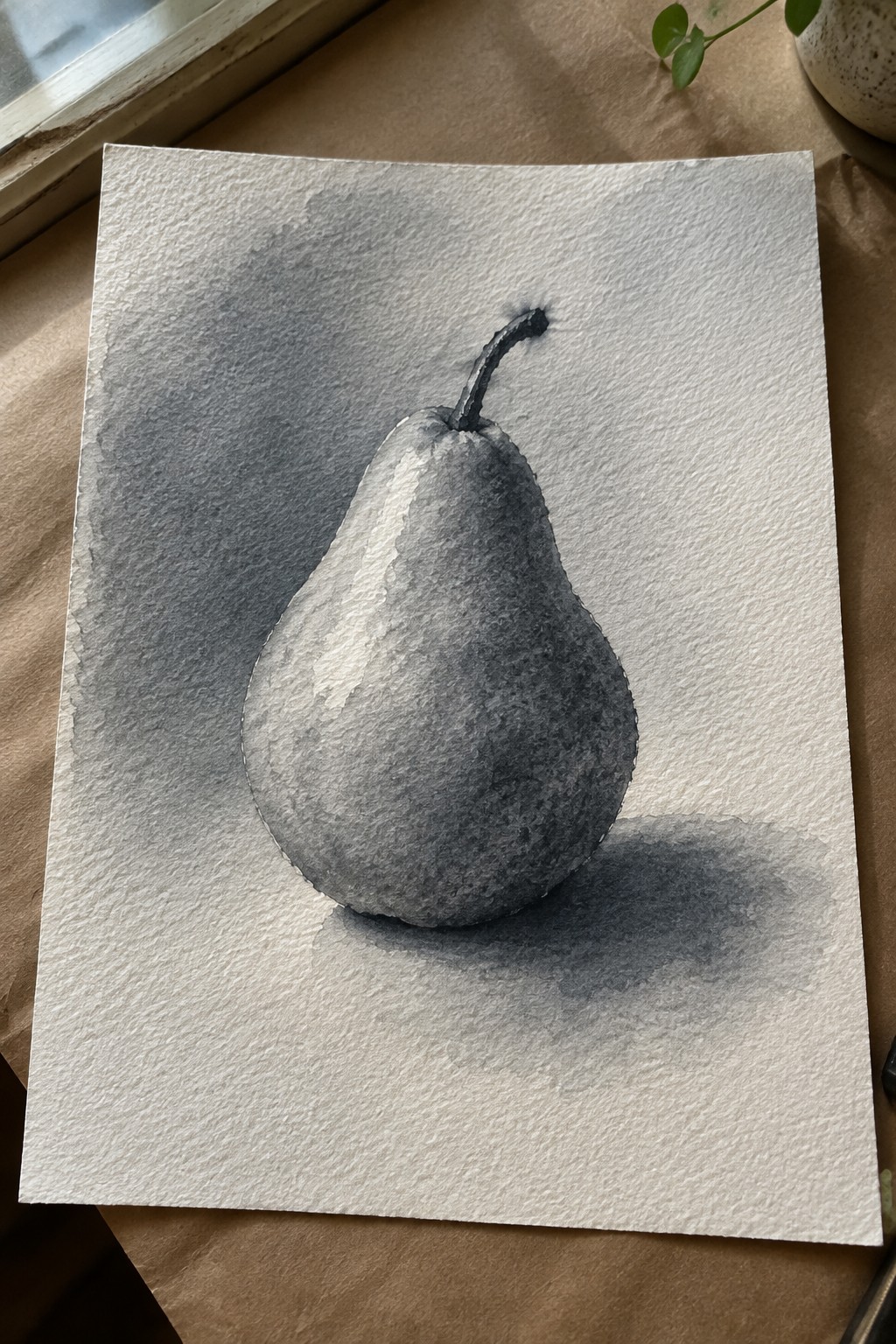 Grayscale watercolor pear with stem and soft shadow on textured white paper