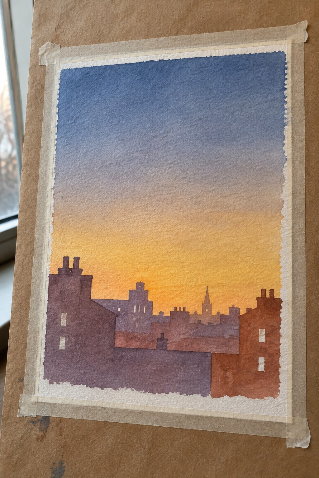 Watercolor painting of a city skyline silhouette against a blue to orange sunset sky, with buildings in shades of purple and orange.