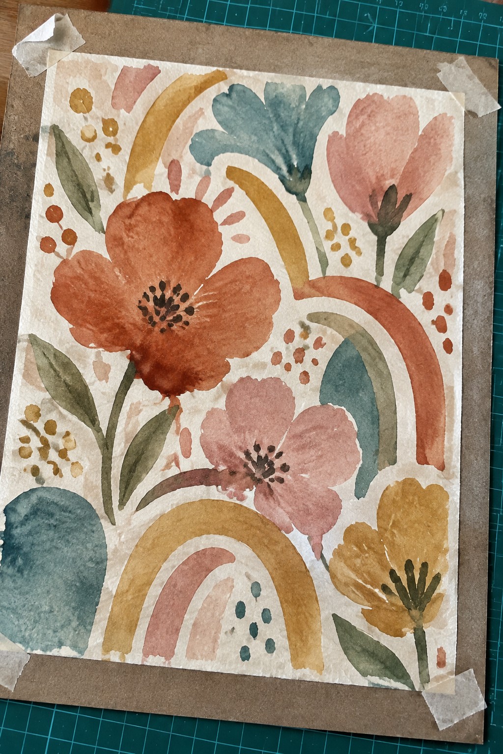 Watercolor floral pattern with orange, pink, yellow blooms, rainbows, and abstract shapes.