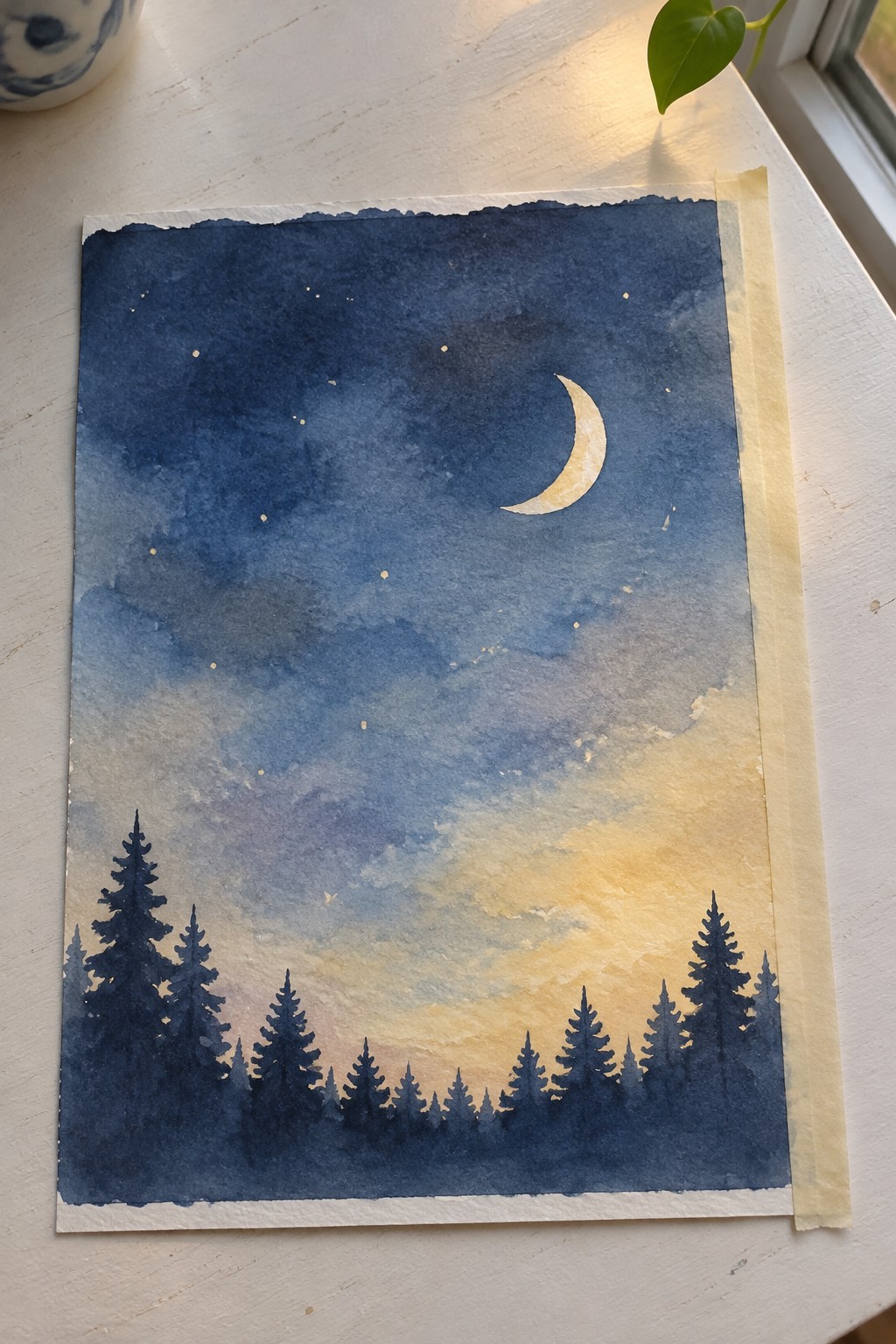 Watercolor night sky with crescent moon, stars, and silhouetted pine trees at glowing horizon