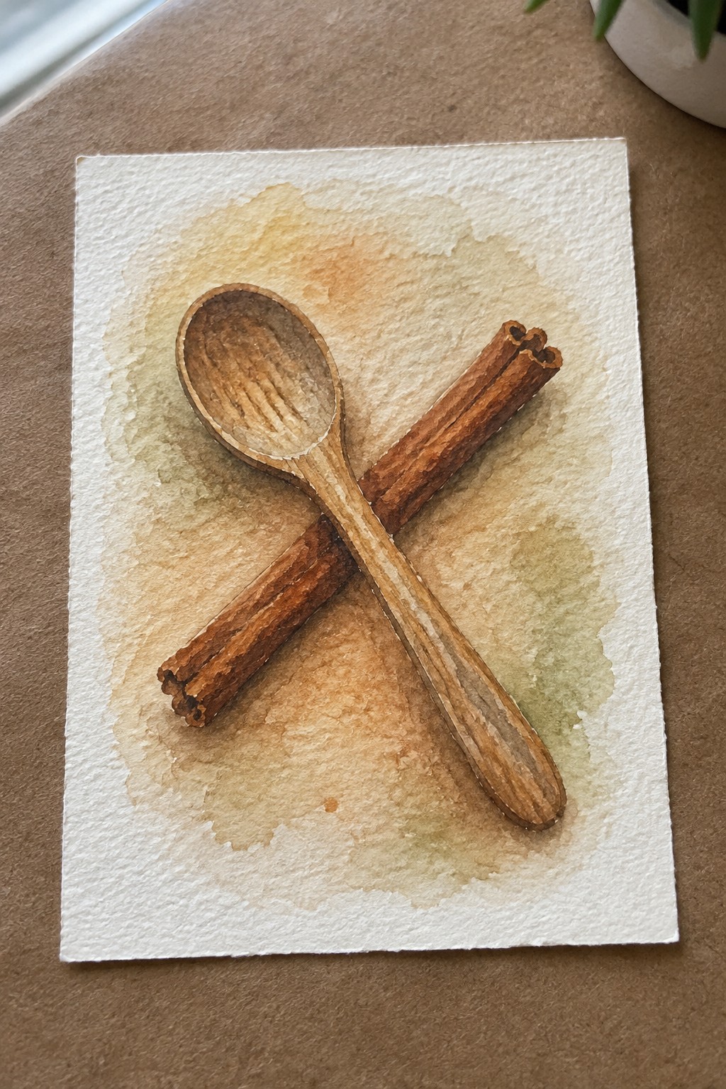 Watercolor painting of a wooden spoon crossed over two cinnamon sticks on a soft blended wash background in browns and greens.