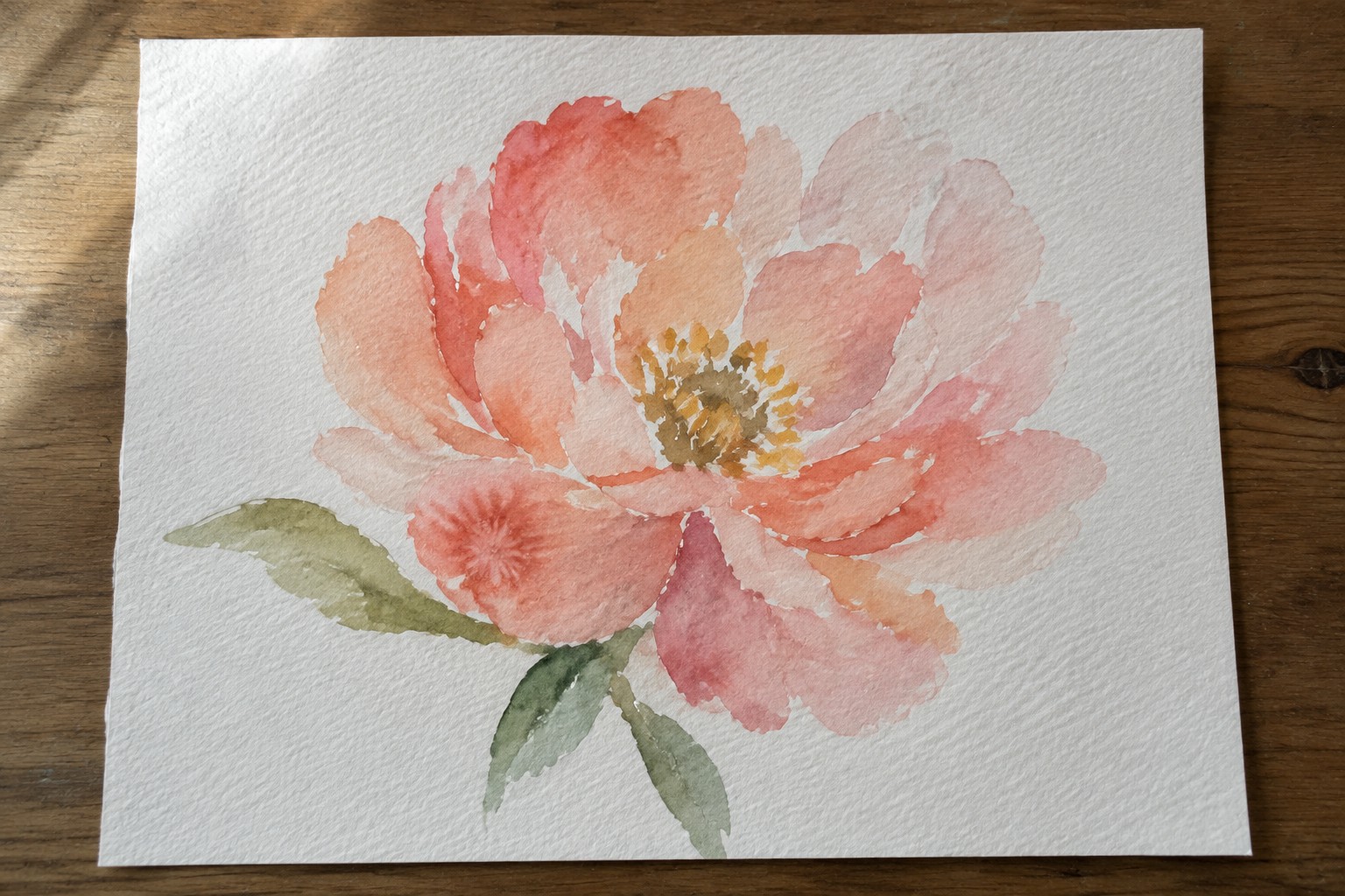 Watercolor painting of a coral pink peony with green leaves on paper