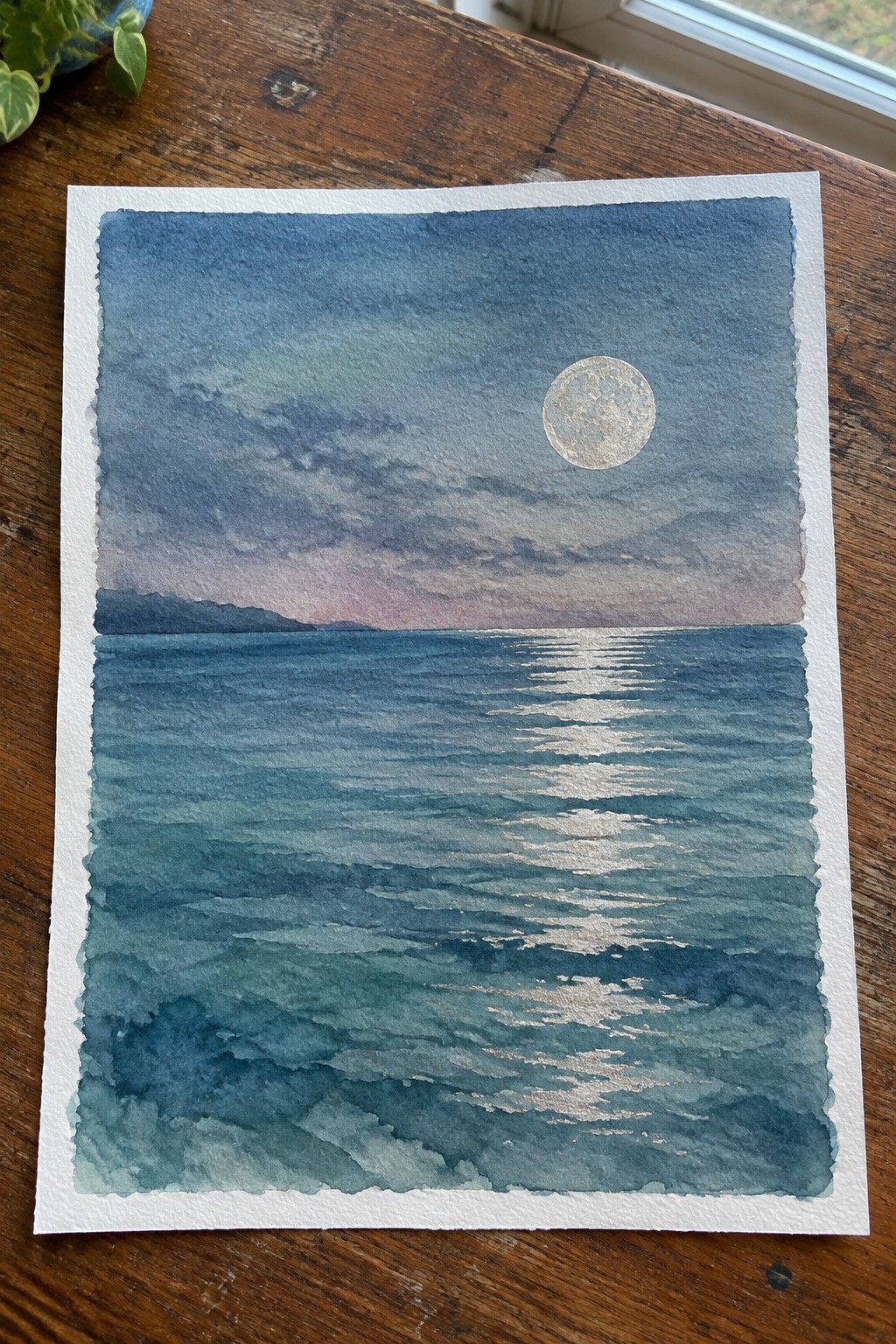 Watercolor seascape of full moon over dark blue ocean waves with silvery moonlight reflection and distant hills.